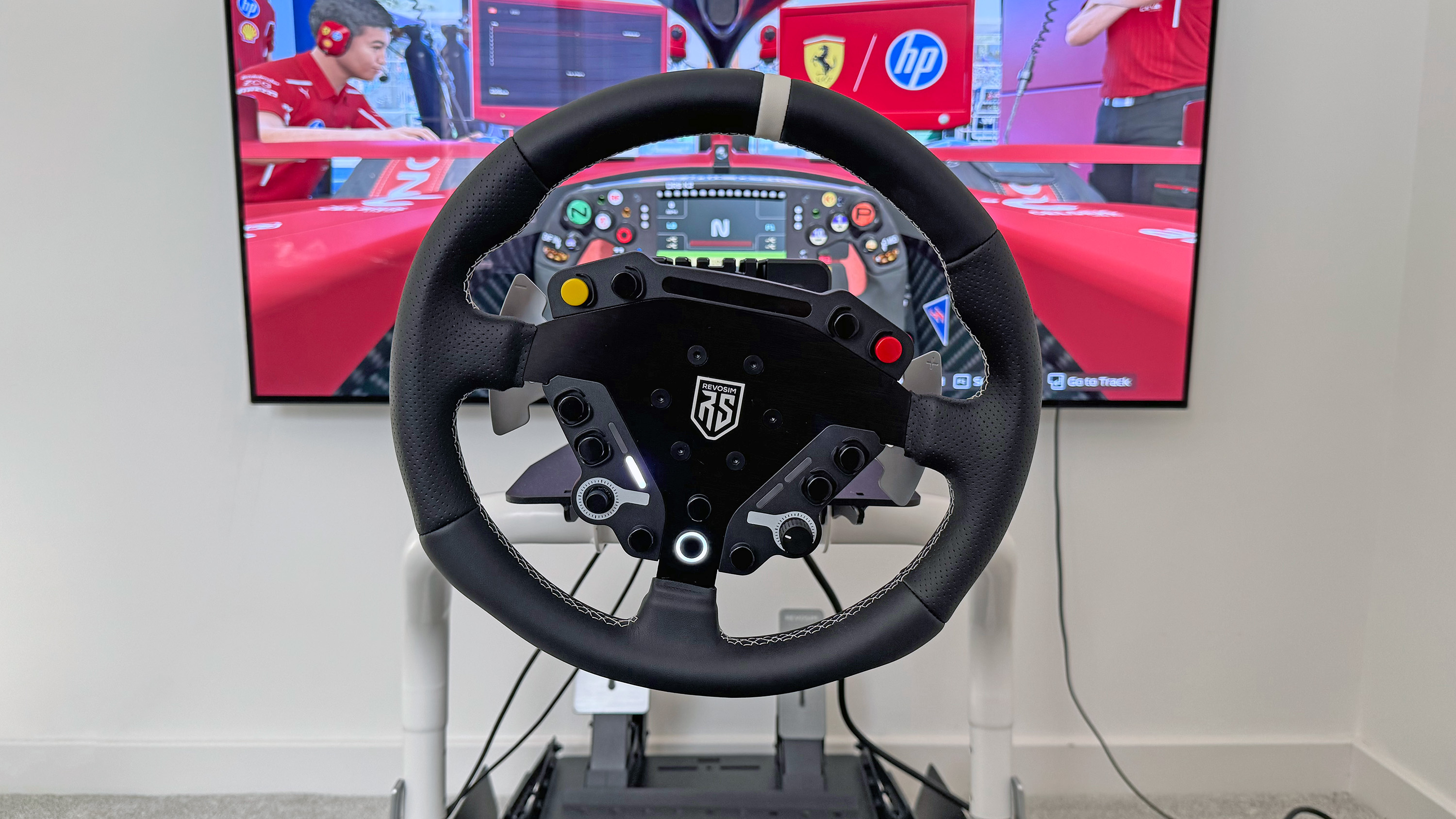 The Nacon Revosim RS Pure bundle's steering wheel in front of a TV